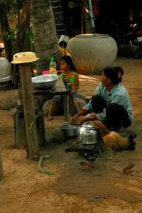 Image of villager washing dishes
